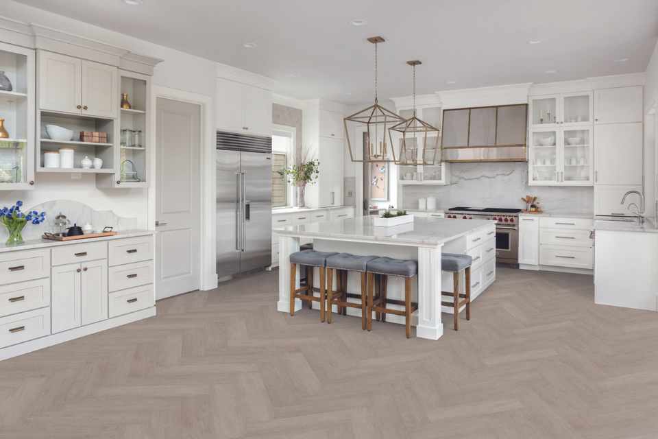 gray herringbone wood look luxury vinyl in white modern kitchen